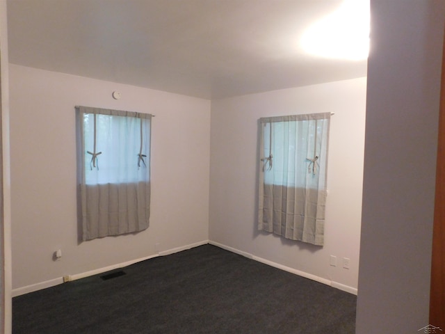 103 W Ludington Dr, Farwell, MI 48622 - unfurnished room featuring baseboards and dark colored carpet