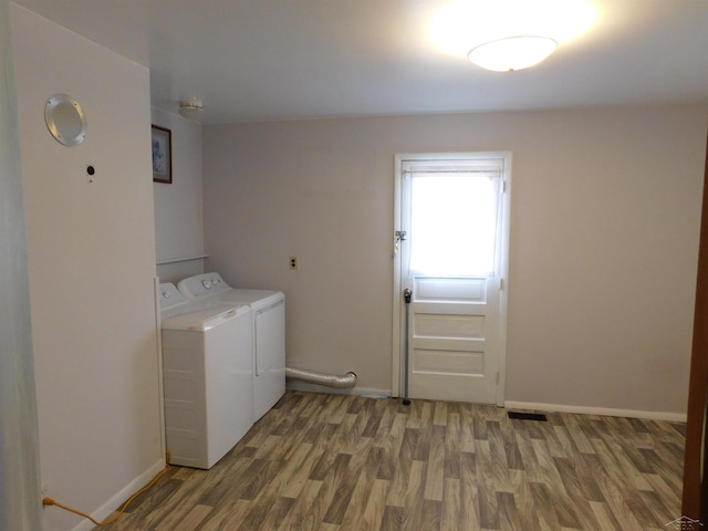 103 W Ludington Dr, Farwell, MI 48622 - washroom with washing machine and dryer, wood finished floors, and baseboards