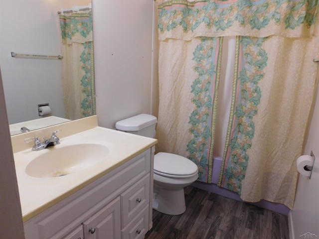 103 W Ludington Dr, Farwell, MI 48622 - full bathroom featuring wood finished floors, vanity, toilet, and shower / bathtub combination with curtain
