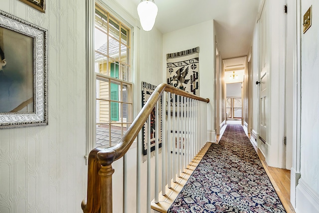 hallway with wood finished floors and baseboards