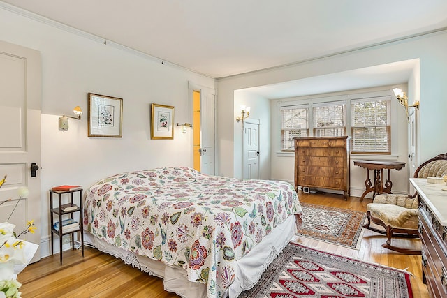 bedroom featuring hardwood / wood-style flooring and crown molding