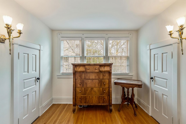 entryway featuring baseboards and wood finished floors