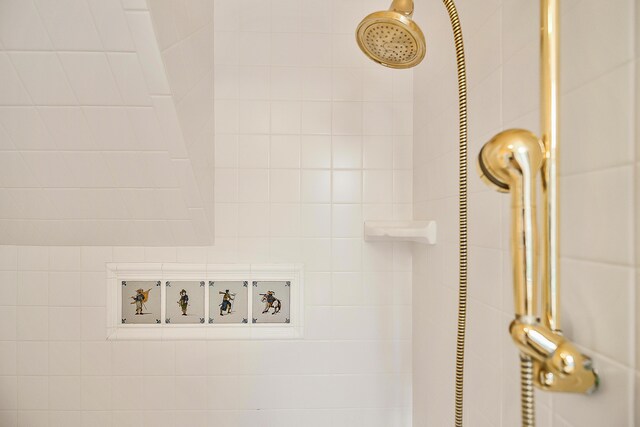 interior details featuring a tile shower