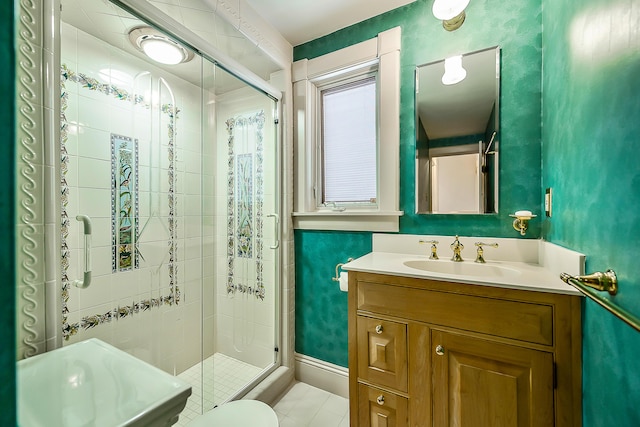 bathroom with tile patterned floors, baseboards, vanity, and a shower stall