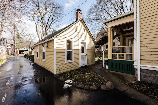 view of property exterior featuring a chimney