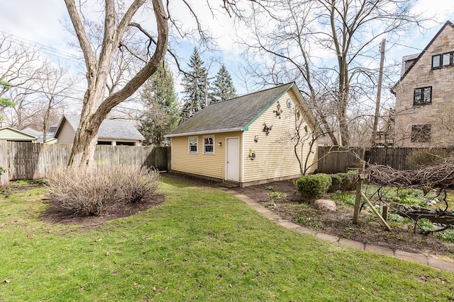 view of yard featuring a fenced backyard and an outbuilding
