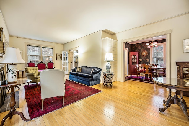 living room with hardwood / wood-style flooring and an inviting chandelier