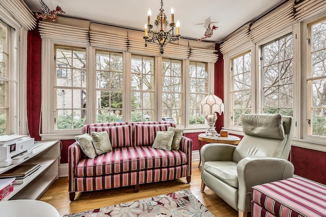 sunroom with an inviting chandelier and french doors