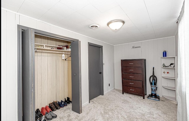 carpeted bedroom with visible vents and two closets