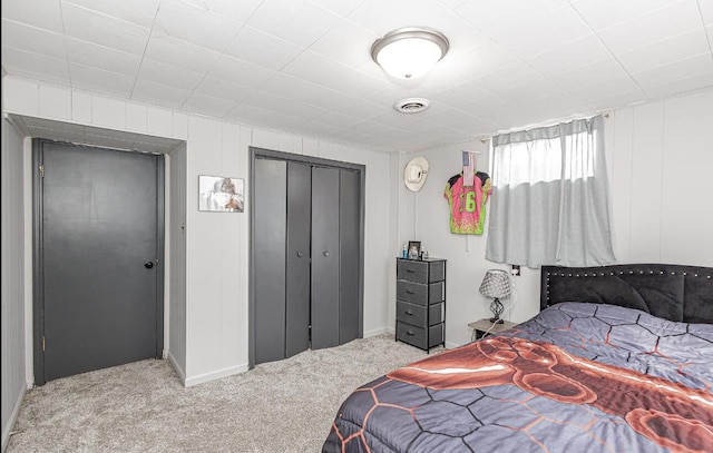 carpeted bedroom with visible vents and a closet