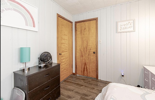 bedroom with dark wood-type flooring