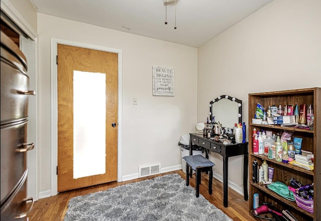 interior space with visible vents, baseboards, and wood finished floors