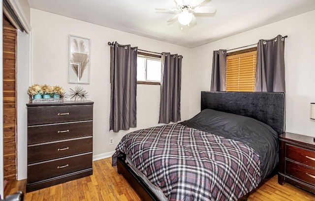 bedroom with wood finished floors, baseboards, and a ceiling fan