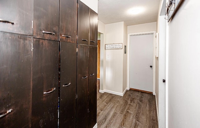 hall with baseboards and wood finished floors