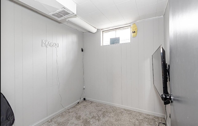 below grade area featuring visible vents, baseboards, and carpet