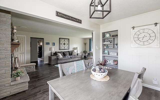 dining area with dark wood-style flooring and built in shelves