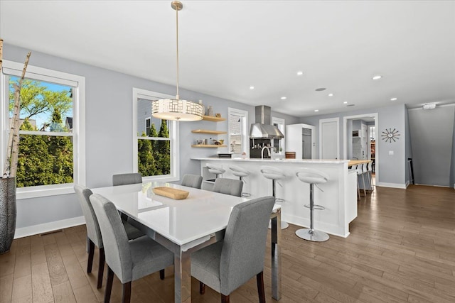 dining area featuring dark wood-style flooring, baseboards, and recessed lighting