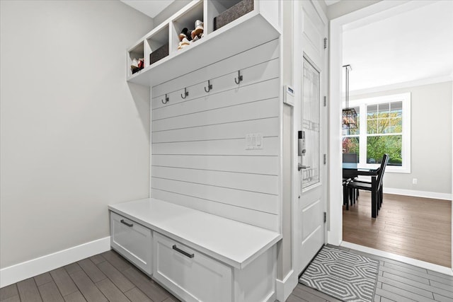 mudroom featuring baseboards and dark wood-style flooring