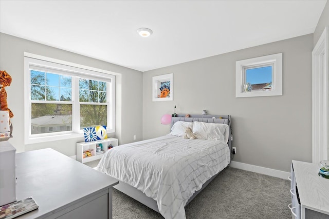 bedroom with carpet floors and baseboards
