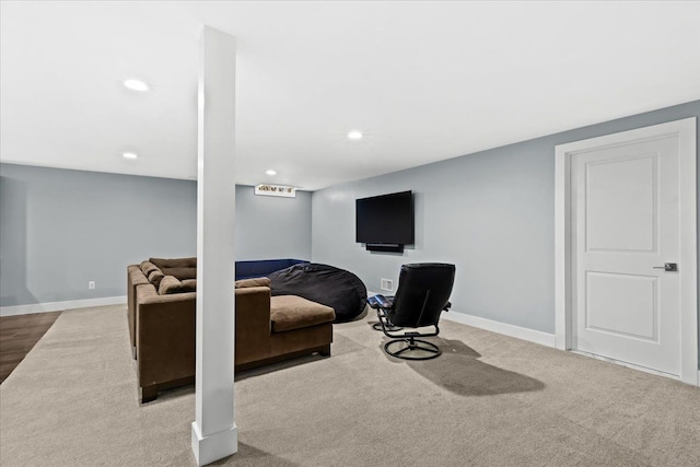 carpeted living area with baseboards and recessed lighting