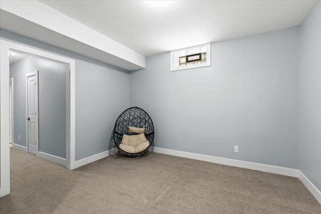basement featuring baseboards and carpet