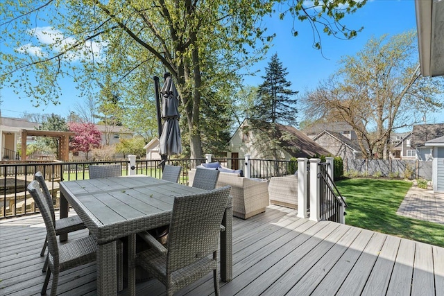 wooden deck with a lawn and outdoor dining space