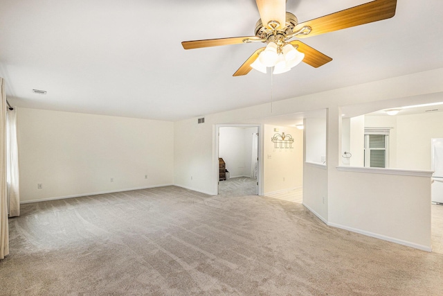 spare room with visible vents, baseboards, a ceiling fan, and light carpet