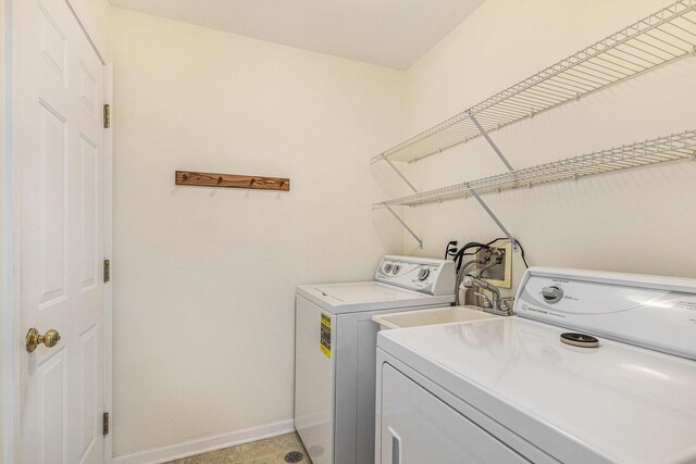 laundry area featuring baseboards, laundry area, and washing machine and clothes dryer