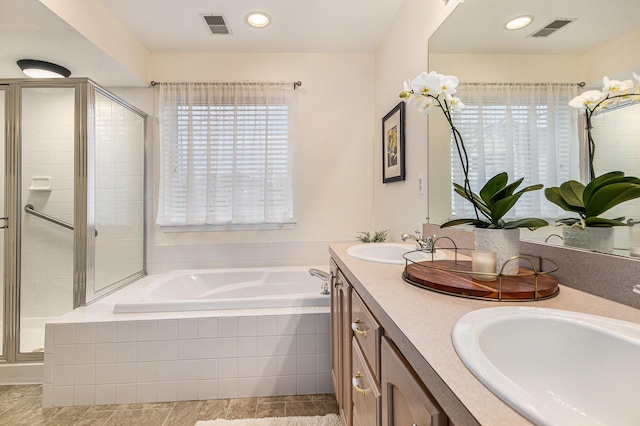 full bath with a shower stall, a garden tub, visible vents, and a sink