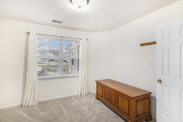 empty room with visible vents, light colored carpet, and baseboards