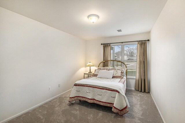 bedroom featuring carpet flooring, visible vents, and baseboards