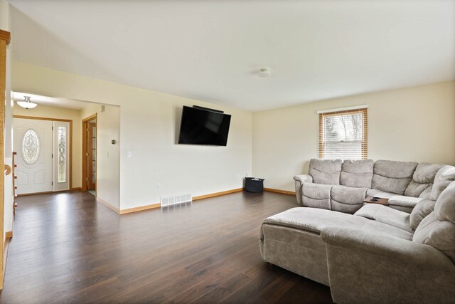 3353 Murphy Lake Rd, Millington, MI 48746 - living area featuring dark wood-type flooring, visible vents, and baseboards