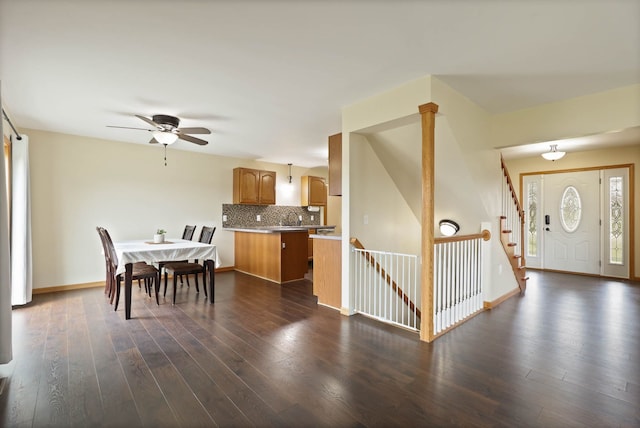 3353 Murphy Lake Rd, Millington, MI 48746 - dining room with dark wood-type flooring, baseboards, a ceiling fan, and stairs