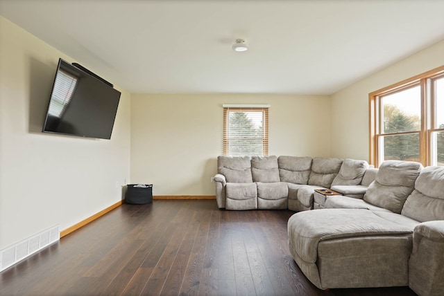 3353 Murphy Lake Rd, Millington, MI 48746 - living room featuring dark wood-type flooring, baseboards, visible vents, and a wealth of natural light