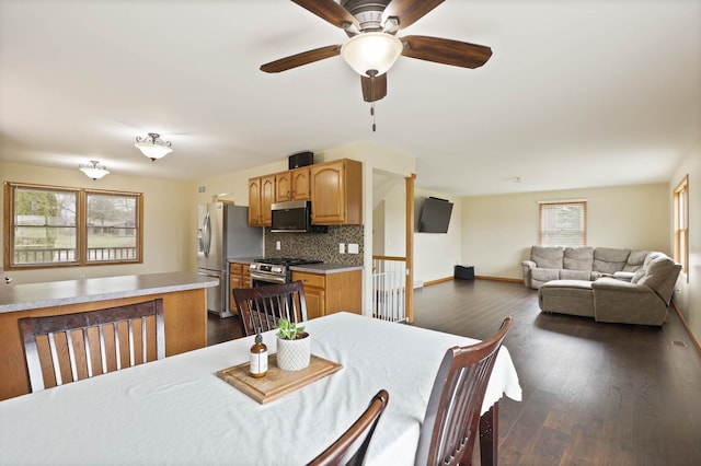 3353 Murphy Lake Rd, Millington, MI 48746 - dining area featuring ceiling fan, baseboards, and dark wood-style floors