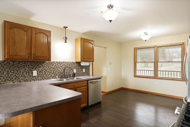 3353 Murphy Lake Rd, Millington, MI 48746 - kitchen with tasteful backsplash, a sink, dark wood finished floors, brown cabinets, and stainless steel dishwasher