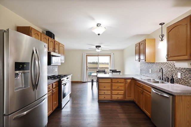 3353 Murphy Lake Rd, Millington, MI 48746 - kitchen with tasteful backsplash, a sink, ceiling fan, appliances with stainless steel finishes, and a peninsula
