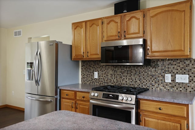 3353 Murphy Lake Rd, Millington, MI 48746 - kitchen featuring tasteful backsplash, visible vents, appliances with stainless steel finishes, and wood finished floors