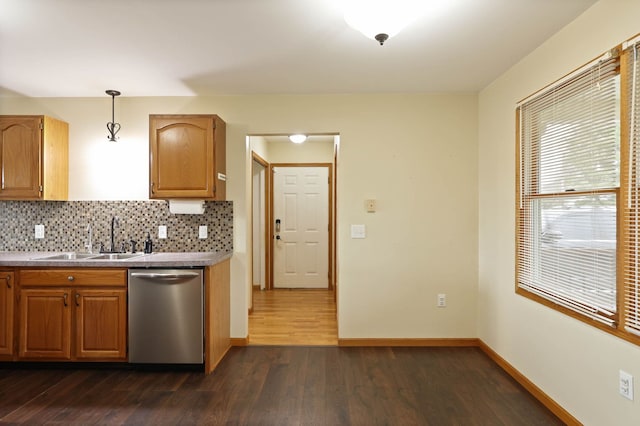 3353 Murphy Lake Rd, Millington, MI 48746 - kitchen featuring stainless steel dishwasher, dark wood finished floors, a sink, baseboards, and backsplash