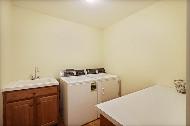 3353 Murphy Lake Rd, Millington, MI 48746 - laundry area with light wood-style flooring, a sink, cabinet space, and washing machine and dryer