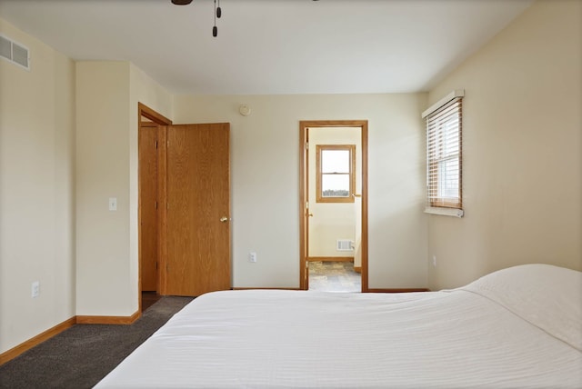 3353 Murphy Lake Rd, Millington, MI 48746 - carpeted bedroom with visible vents, baseboards, a ceiling fan, and ensuite bathroom