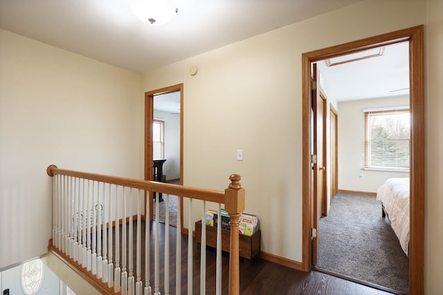 3353 Murphy Lake Rd, Millington, MI 48746 - hall featuring dark wood-style flooring, baseboards, and an upstairs landing