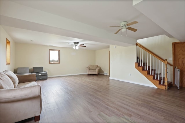 3353 Murphy Lake Rd, Millington, MI 48746 - living room featuring baseboards, a ceiling fan, wood finished floors, and stairway