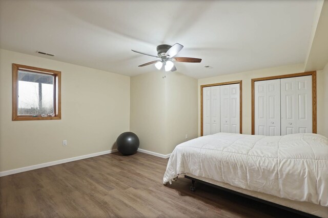 3353 Murphy Lake Rd, Millington, MI 48746 - bedroom featuring baseboards, visible vents, multiple closets, ceiling fan, and wood finished floors