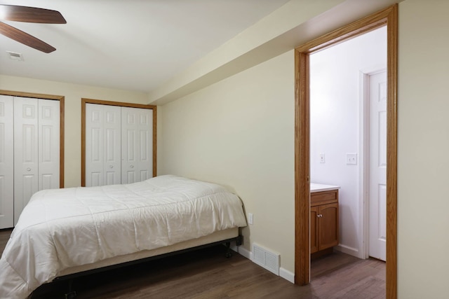 3353 Murphy Lake Rd, Millington, MI 48746 - bedroom featuring visible vents, baseboards, two closets, and dark wood-style floors