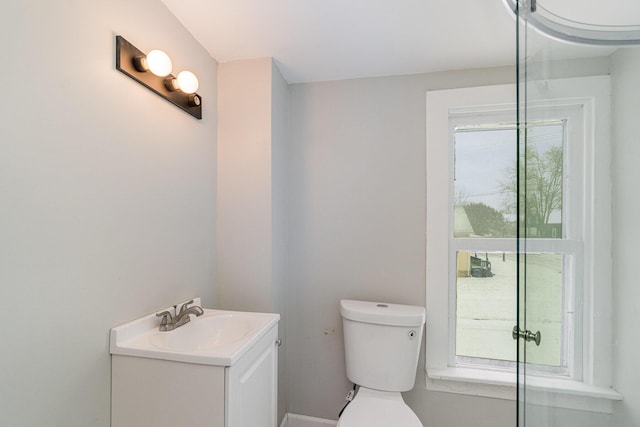 921 S Jackson St, Bay City, MI 48708 - bathroom with toilet, vanity, and a wealth of natural light