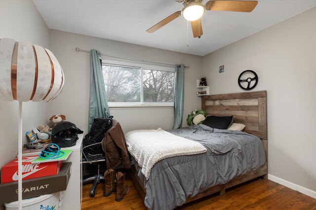 bedroom with wood finished floors, ceiling fan, and baseboards