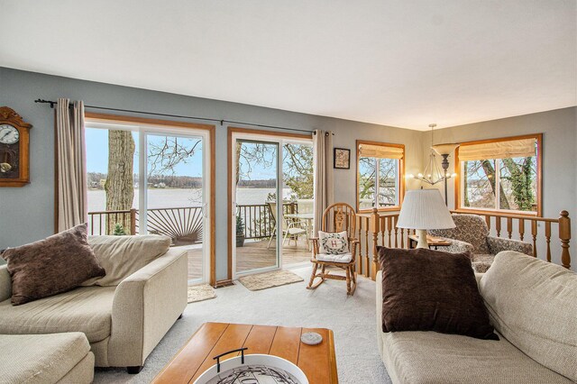 15095 N Barton Lake Dr, Vicksburg, MI 49097 - living area featuring a water view, a chandelier, and light carpet