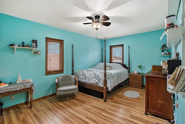 15095 N Barton Lake Dr, Vicksburg, MI 49097 - bedroom featuring baseboards, a ceiling fan, light wood-style floors, and a textured ceiling
