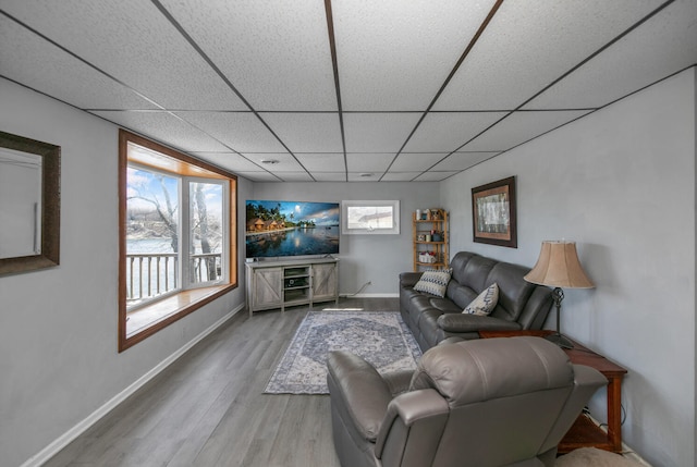 69465 High St, Union, MI 49130 - living area with wood finished floors, a paneled ceiling, and baseboards